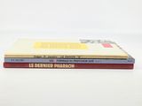 three books stacked on top of each other on a white surface