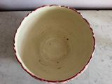 a white and red bowl sitting on a marble counter