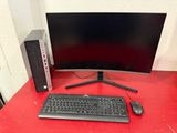 a computer monitor and keyboard on a red desk