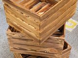 three wooden crates stacked on top of each other in a warehouse