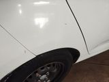 a close up of a white car with black rims