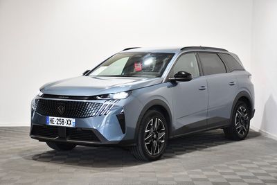 a grey 2021 hyundai kona suv parked in a white room