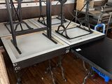 a table that has some chairs on it in a room