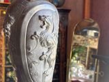 a vase that is sitting on a table in front of a mirror