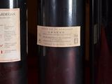 three bottles of wine are lined up on a table