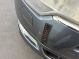 a close up of a car ' s front bumper with a sticker on it