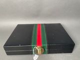 a black box with a green and red stripe on it
