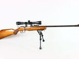 the rifle is on a stand with a scope attached to it