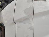 a close up of a white truck with its door open