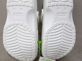 the soles of a pair of white tennis shoes with a price tag