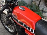a red motorcycle parked on the side of the road