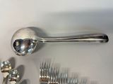 a lot of silver spoons and forks on the table