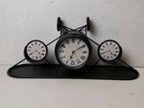 three clocks that are sitting on top of a shelf