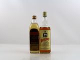 two bottles of liquor sitting next to each other on a table