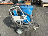 a blue machine that is sitting in the parking lot