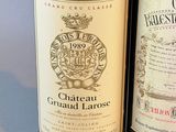 two bottles of wine sitting next to each other on a table