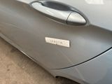 a close up of a car door handle with a sticker on it