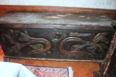 a wooden chest with a dragon design on it