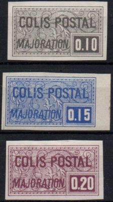 four different colored postages on a black background