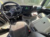 a view of the inside of a truck with a steering wheel