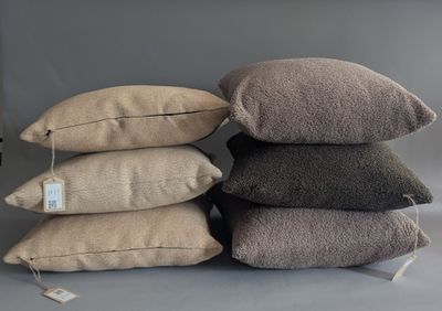 several pillows are stacked on top of each other on a table