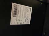 a picture of a black suitcase with a ticket attached to it