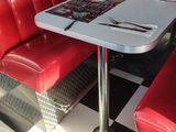 a red booth with a white table and red chairs