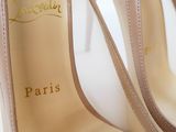 the bottom of a pair of nude colored high heel shoes