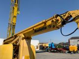 a yellow crane that is sitting in a parking lot