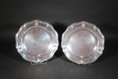 pair of silver plated dishes on stand on black background