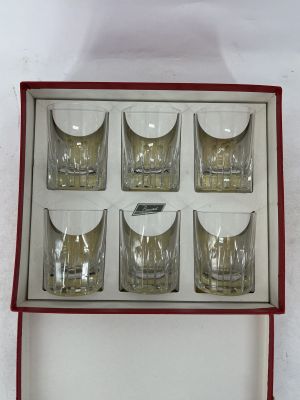 six shot glasses in a red box on a white surface