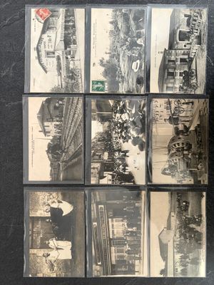 several old black and white photographs of people and vehicles on a table