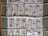 a picture of a green and white scarf with birds on it
