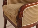 a chair with a striped upholstered back and arms