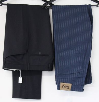 two men ' s pants hanging on a clothes hanger on a white wall
