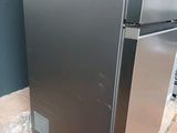 an image of a stainless steel refrigerator in the middle of a room