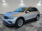 un SUV Volkswagen argenté garé sur un sol en carrelage à damier