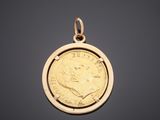 a gold coin pendant with a portrait of a man on it