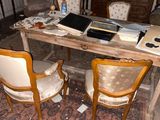 a table with a laptop on it in the middle of a living room