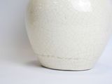 a white vase that is sitting on a table