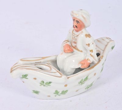 une figurine représentant un homme dans un bateau, posée sur une surface blanche