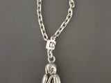 un gros plan d'un collier en argent orné d'un oiseau