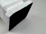 a black and white object on a white surface
