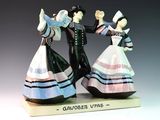 two figurines of a man and a woman dancing