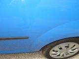 a blue car that has a black door handle on it