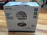 a box that has a fan inside of it on a table