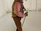 a figurine of a man with a hat and a cane