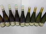 six bottles of wine are lined up in a row on a table