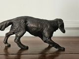 a black dog figurine on a wooden floor