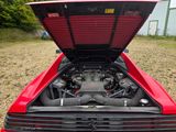 a red car with its hood open and the hood up